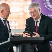 Mario Kreft MBE, the chair of Care Forum Wales, presenting former First Minister Mark Drakeford with a Wales Care Award