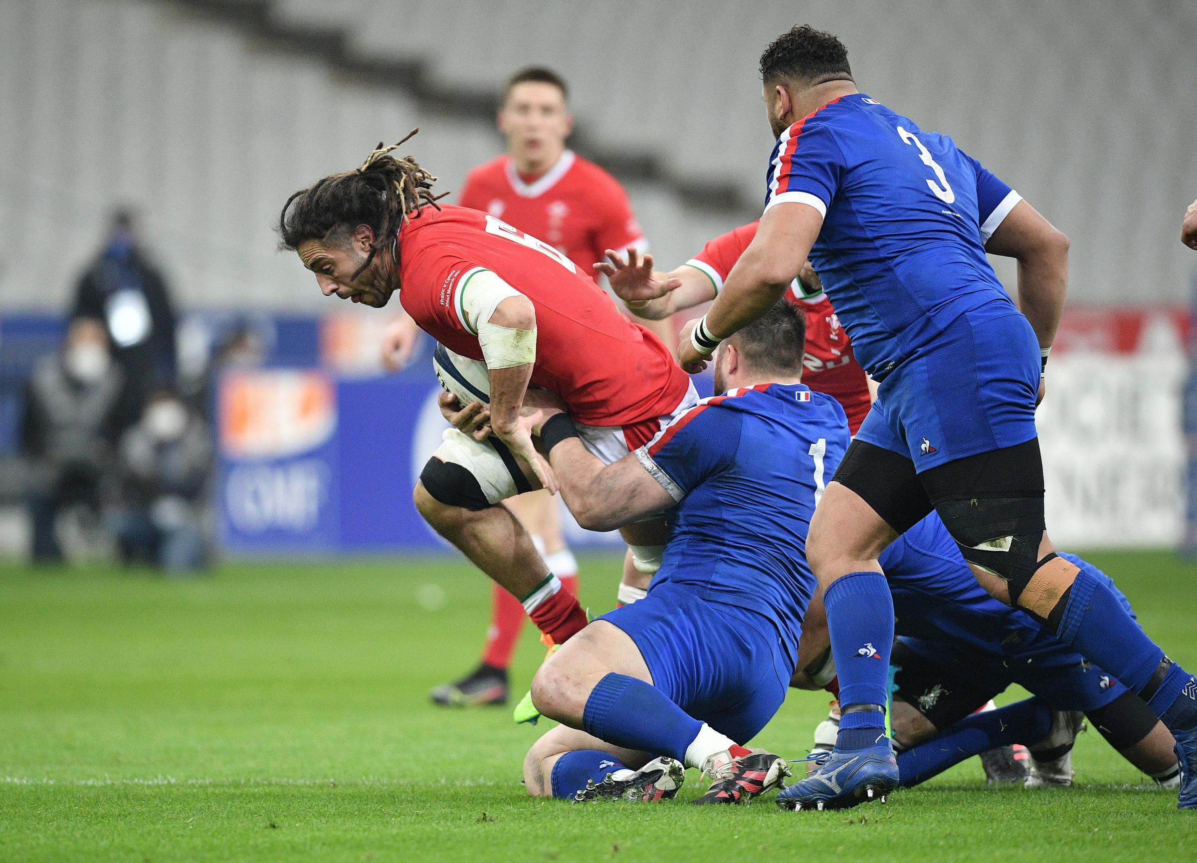 Wales’ Josh Navidi (left) is tackled during the Guinness Six Nations match at Stade de France, Paris. Picture date: Saturday March 20, 2021. PA Photo. See PA story RUGBYU France. Photo credit should read: David Niviere/PA Wire. ..Use subject to