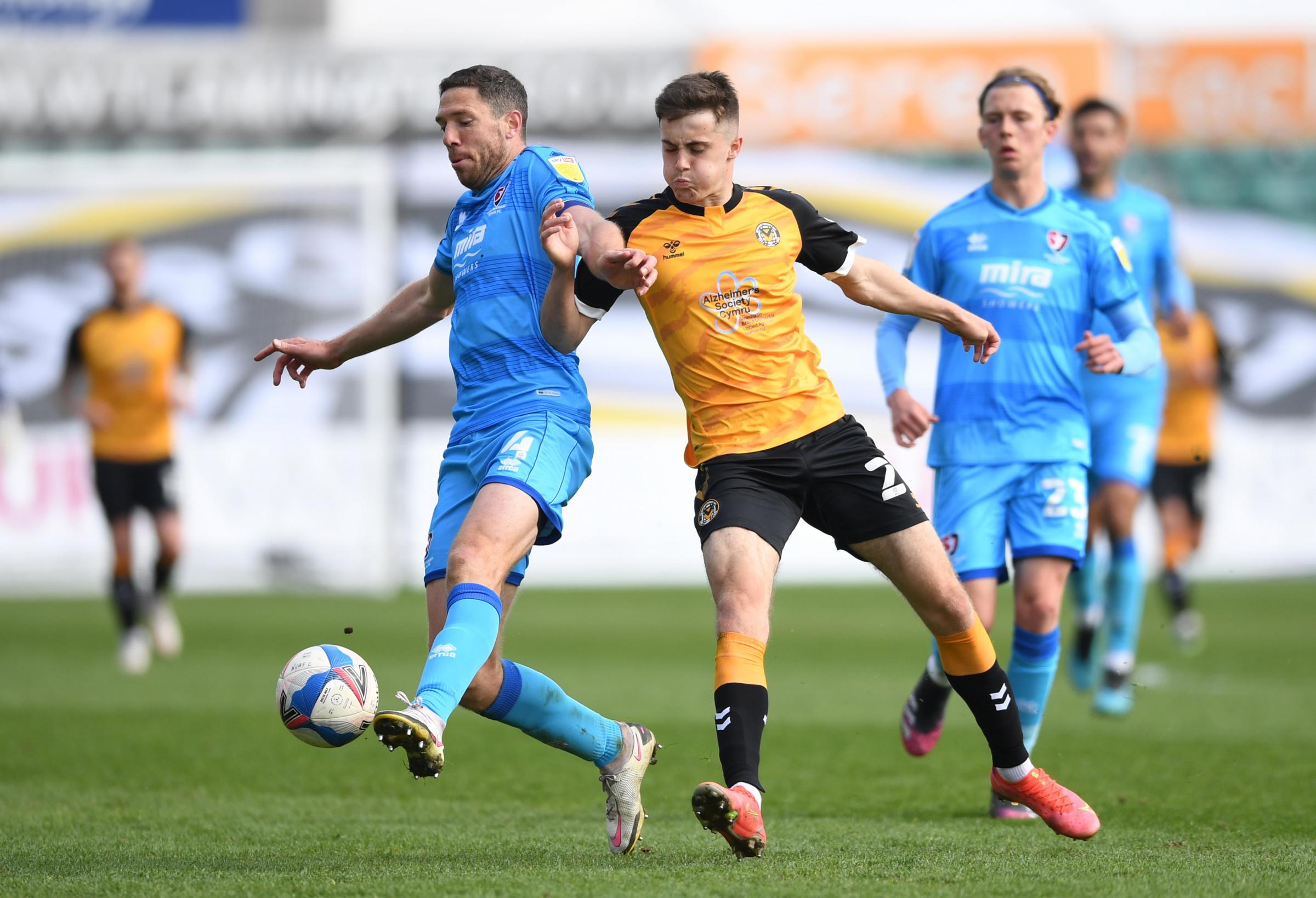 01.05.21 - Newport County v Cheltenham Town - SkyBet League 2 -.Ben Tozer of Cheltenham Town is tackled by Lewis Collins of Newport County..