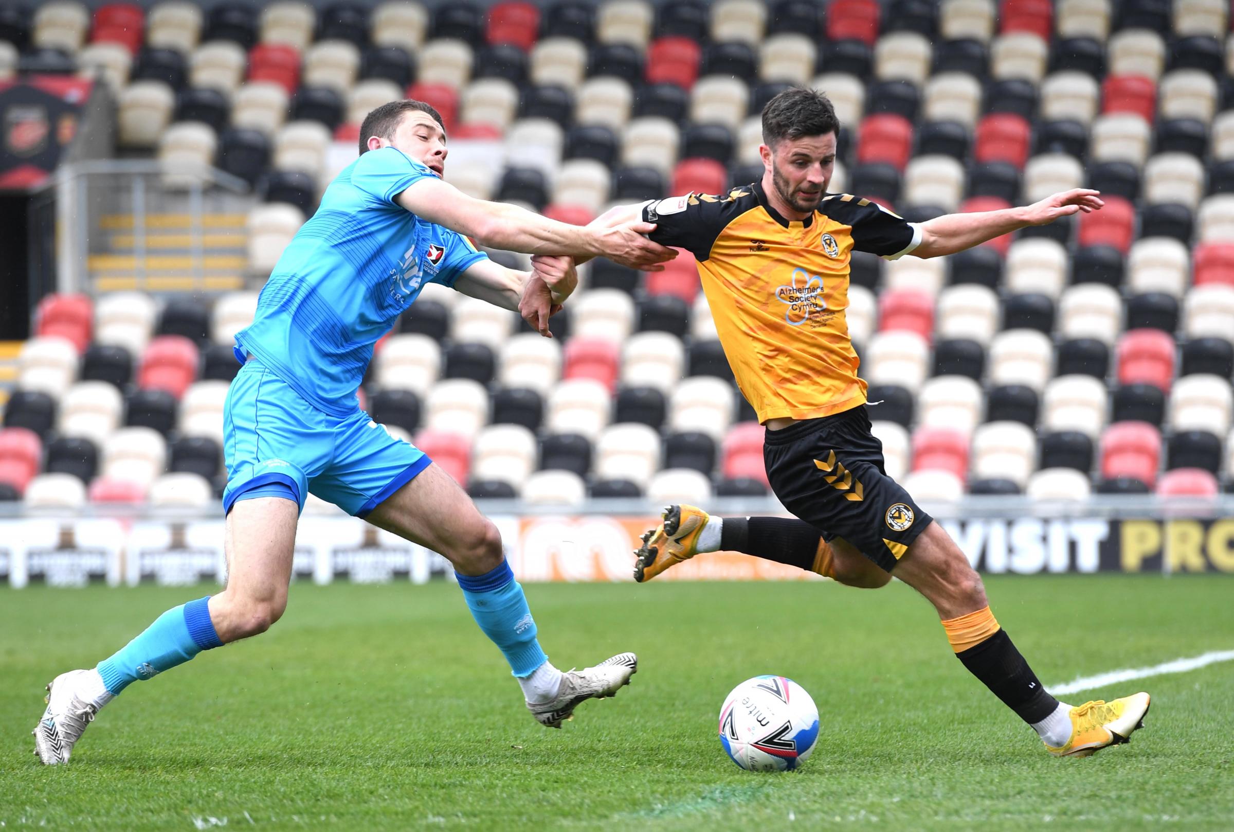 ENERGY: Padraig Amond of Newport County is tackled by Sean Long of Cheltenham Town.