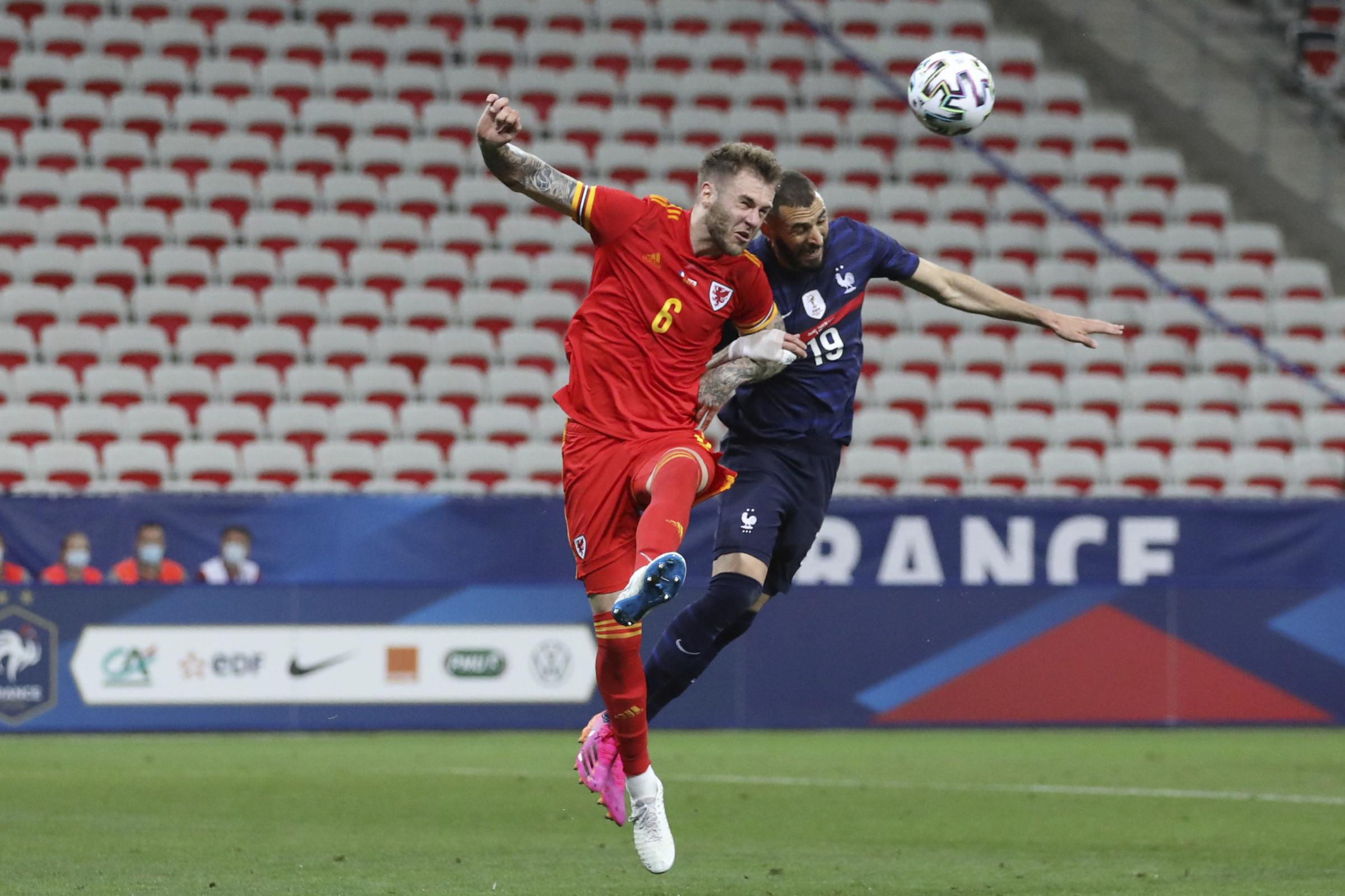 TUSSLE: Centre-back Joe Rodon challenges France’s Karim Benzema