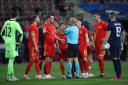 FRUSTRATION: Wales’ Gareth Bale argues with the referee after he awarded a penalty and sent off Neco Williams