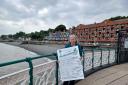 Council leader Lis Burnett holding the 'ideas board' filled with suggestions on how to improve the Esplanade