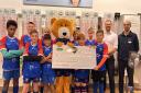 Specsavers Penarth present U12 Penarth Bears with £400 cheque for new equipment