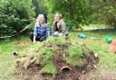 Ecologists Laura and Ella putting the finishing touches to the hibernaculum at Victoria Square in Penarth