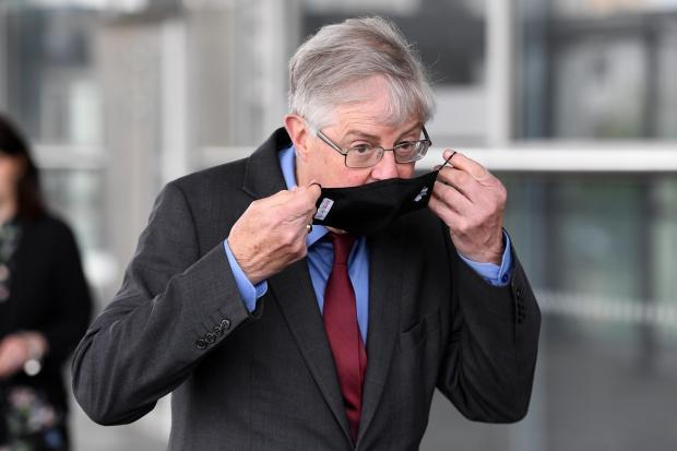 Penarth Times: Mark Drakeford putting on a face covering heading into the Senedd. Picture: Huw Evans Picture Agency