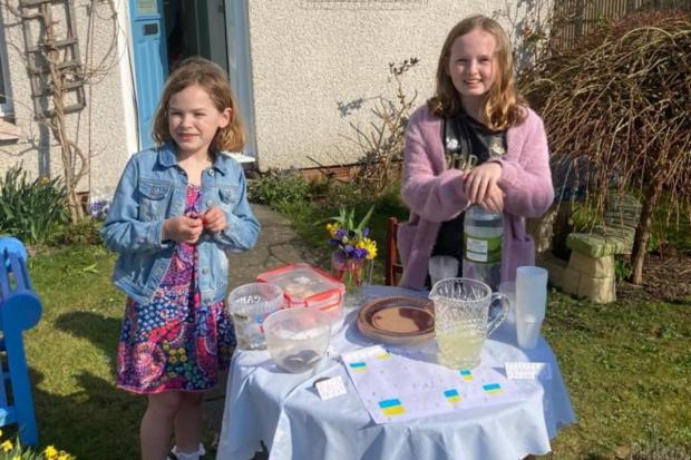Penarth Times: Christina and her little sister Hayley at their stall raising money for Newsquest's Ukraine appeal.