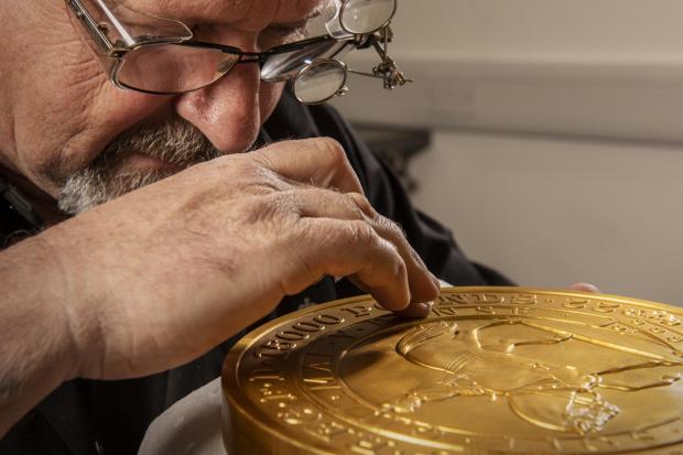 Penarth Times: Master craftsman Steve Dyer works on the 15 kilo gold coin by hand. Credit: The Royal Mint