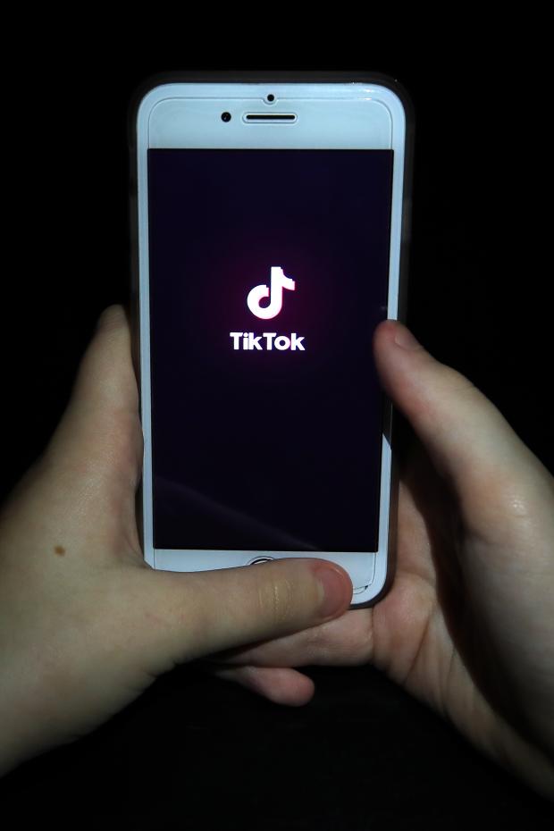 Penarth Times: A person with TikTok open on their phone. Credit: PA