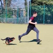 Alan, a residential pupil at Headlands School, runs with Dexter