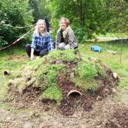 Ecologists Laura and Ella putting the finishing touches to the hibernaculum at Victoria Square in Penarth