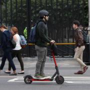 General picture of a person riding an e-scooter.