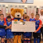 Specsavers Penarth present U12 Penarth Bears with £400 cheque for new equipment