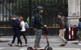 General picture of a person riding an e-scooter.