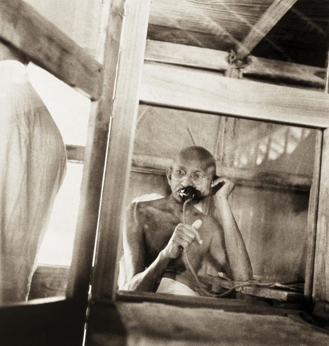 Mahatma Gandhi telephoning from the office hut in Sevagram Ashram, 1938. Picture: Kanu Gandhi/The Estate of Kanu Gandhi